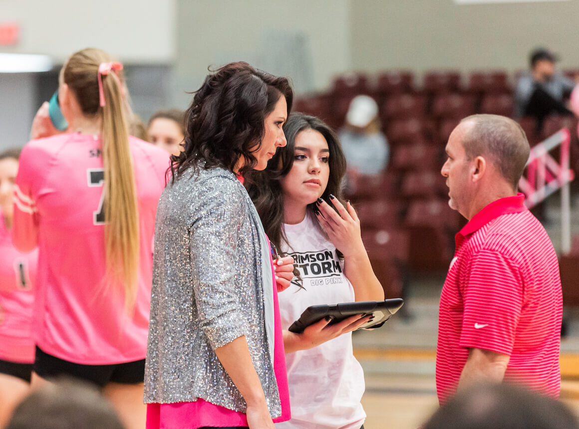 Coach and Student discussing sports management in volleyball game