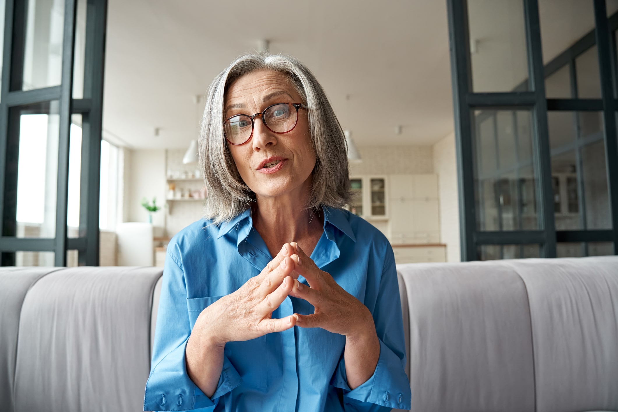 Woman looking at the camera explaining something