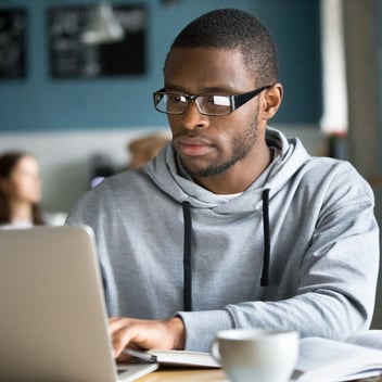 Male Student Working on Laptop