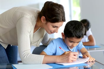 Teacher Helping Student with Writing Lesson