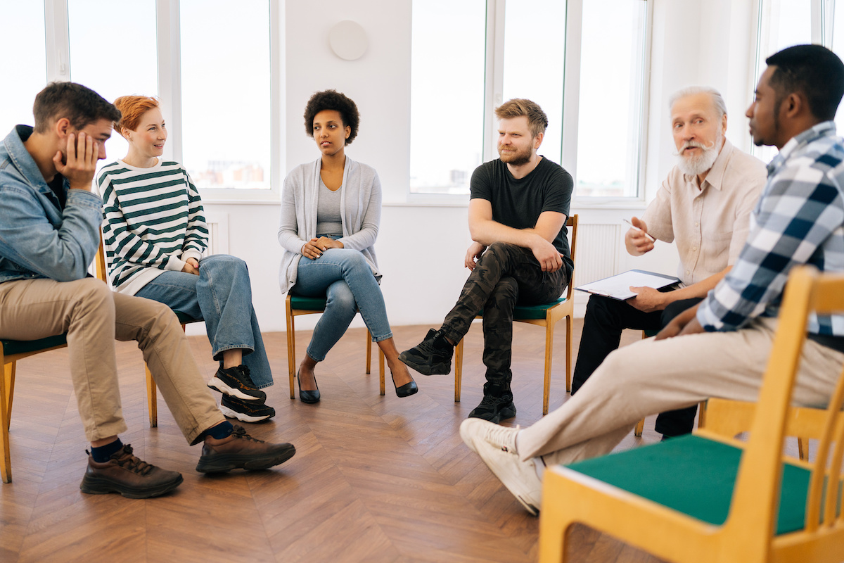 Group of people sitting in a circle talking