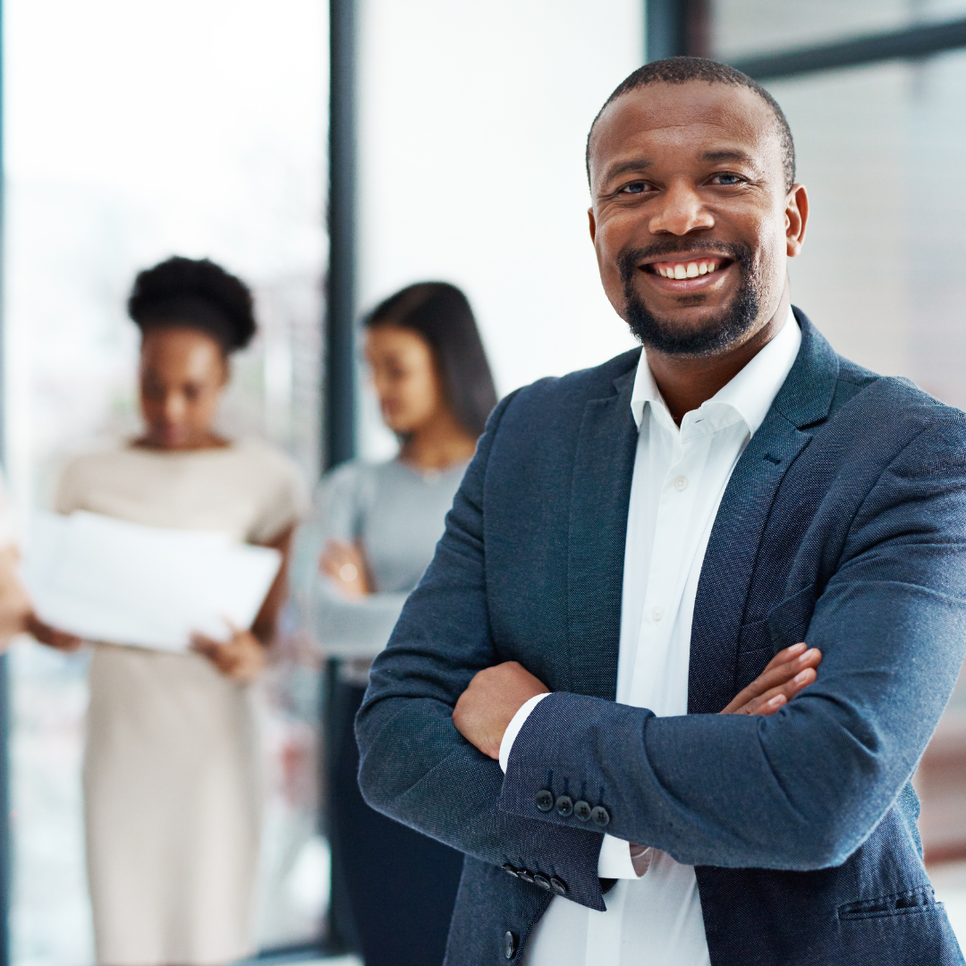 Business Leader with Staff in the Background