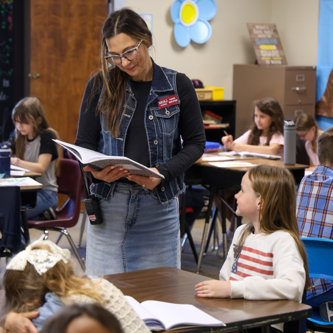 A teacher reviewing a student's work.