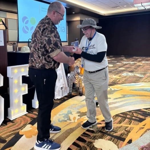 Perry Diehm accepts the Distinguished Service Award at the 2025 OASFAA Conference