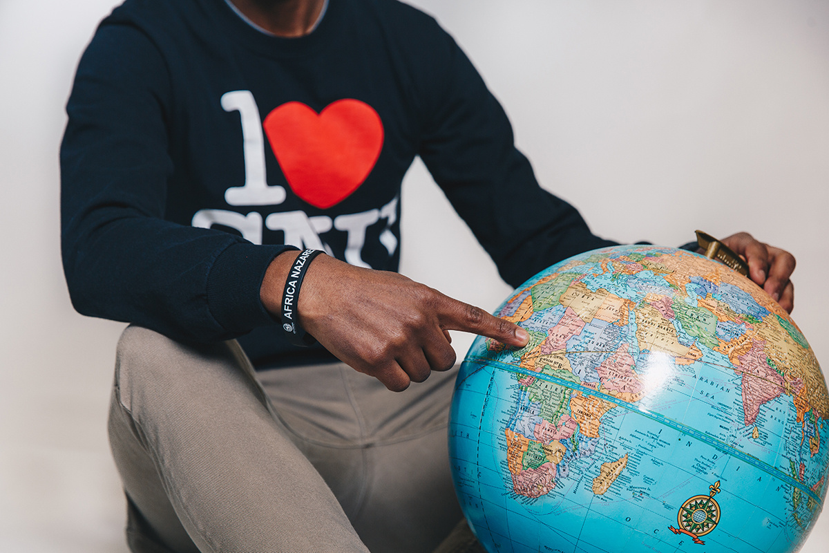 student pointing to globe