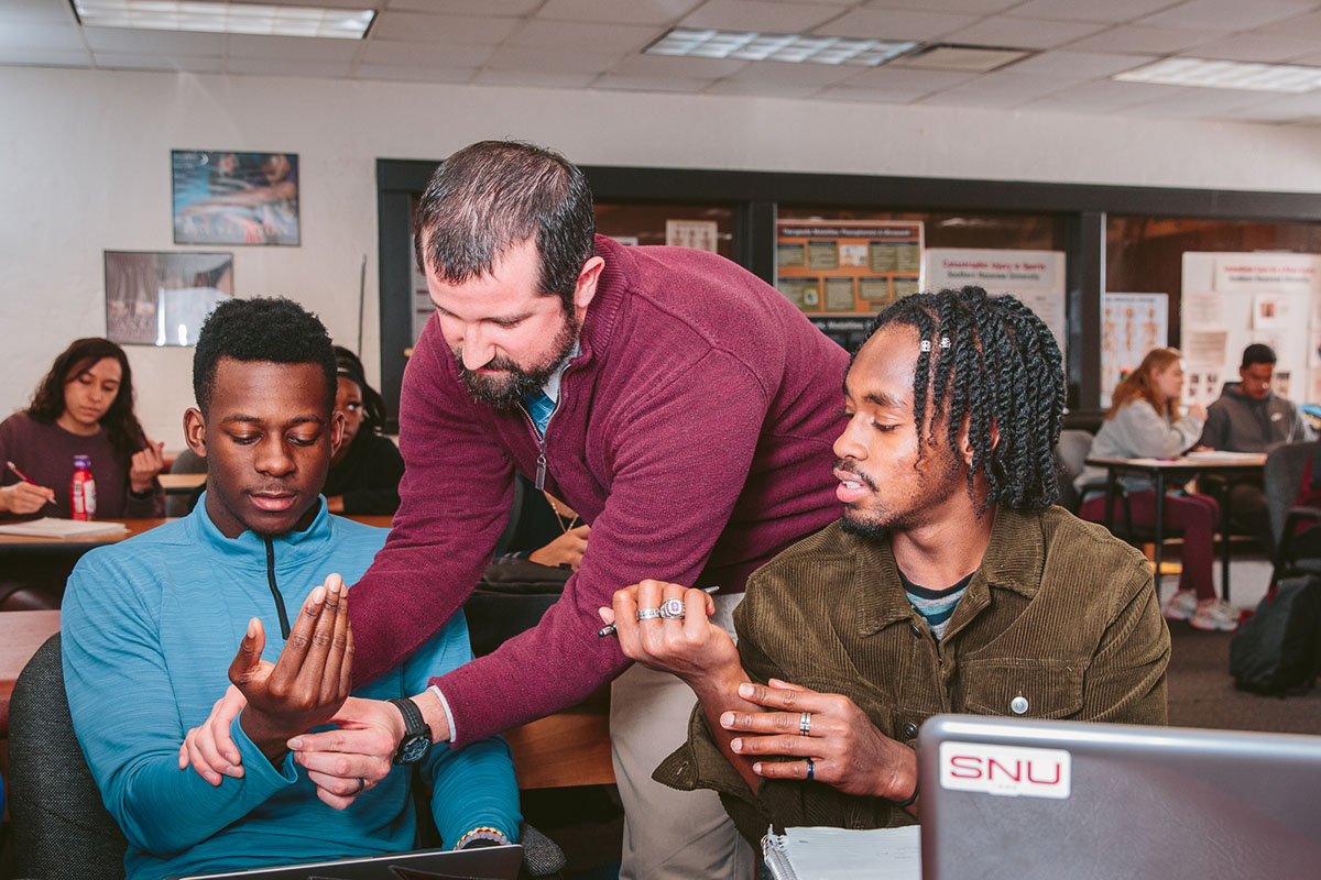 Students examine arms in class