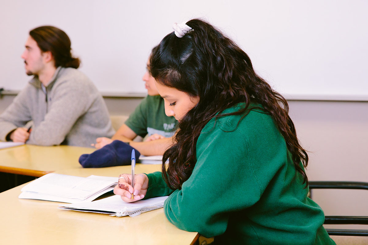 Student takes notes in class