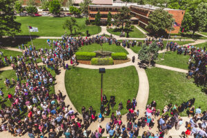 view from above of a crowd of alumni on the campus grounds