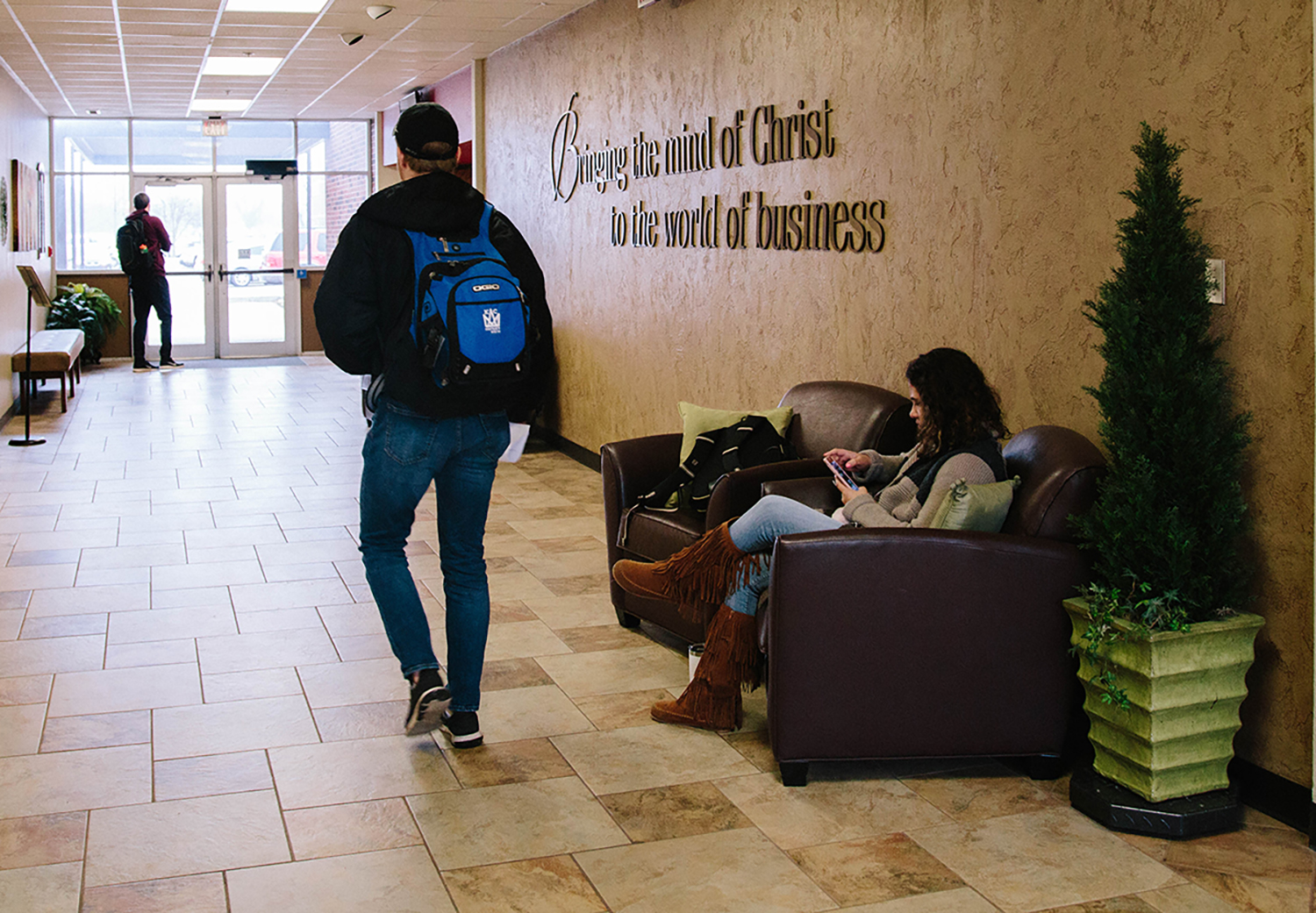 students walking in the school of business building