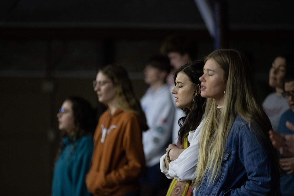 Students standing and praying