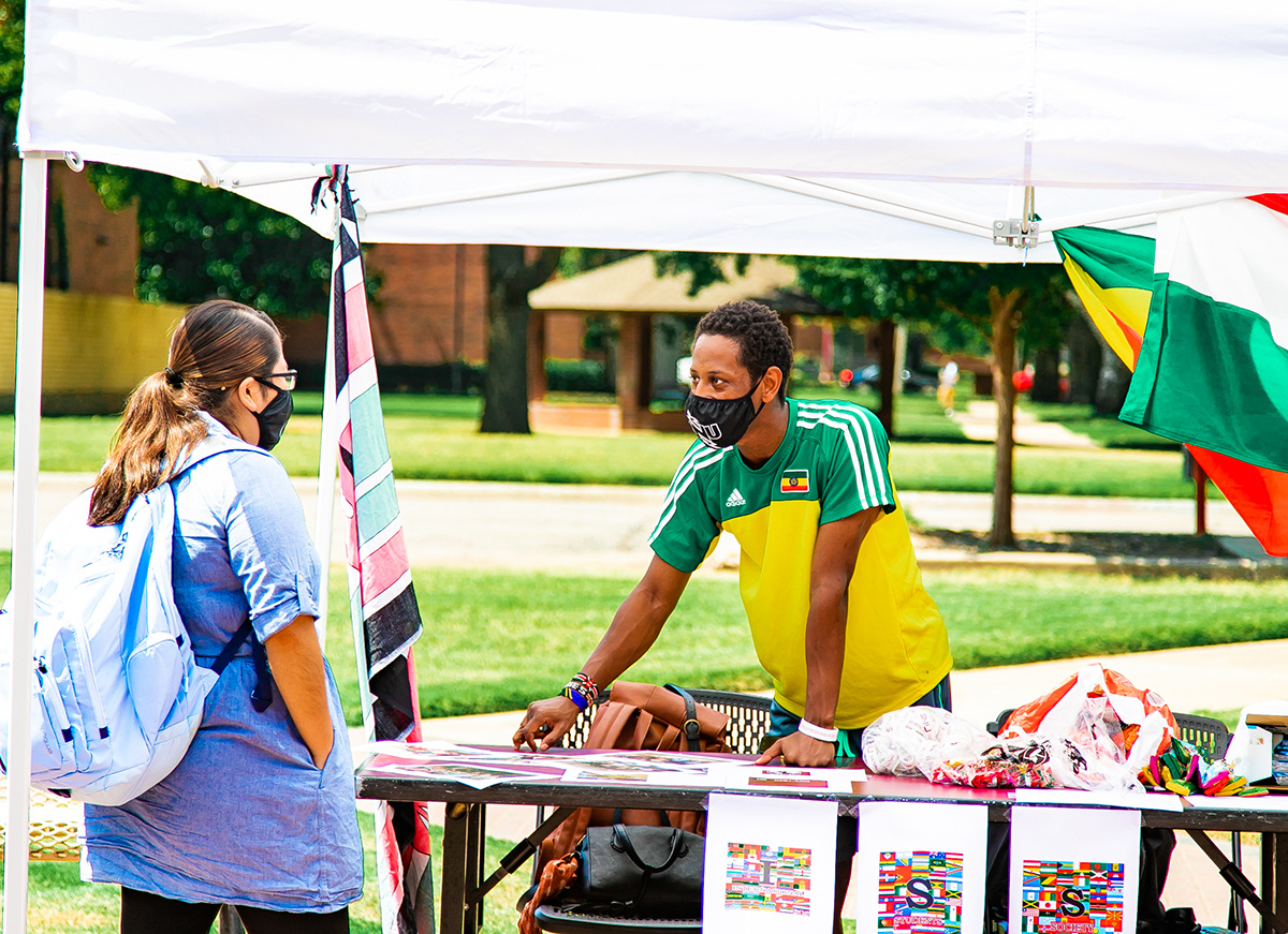 students talking at the outdoor club fair