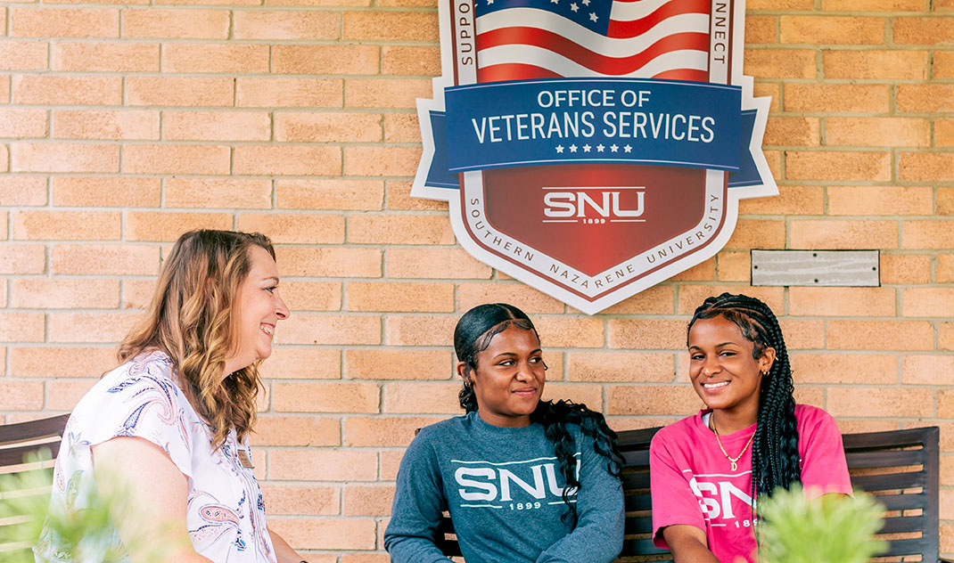 two students sitting outside the VETS Center at SNU