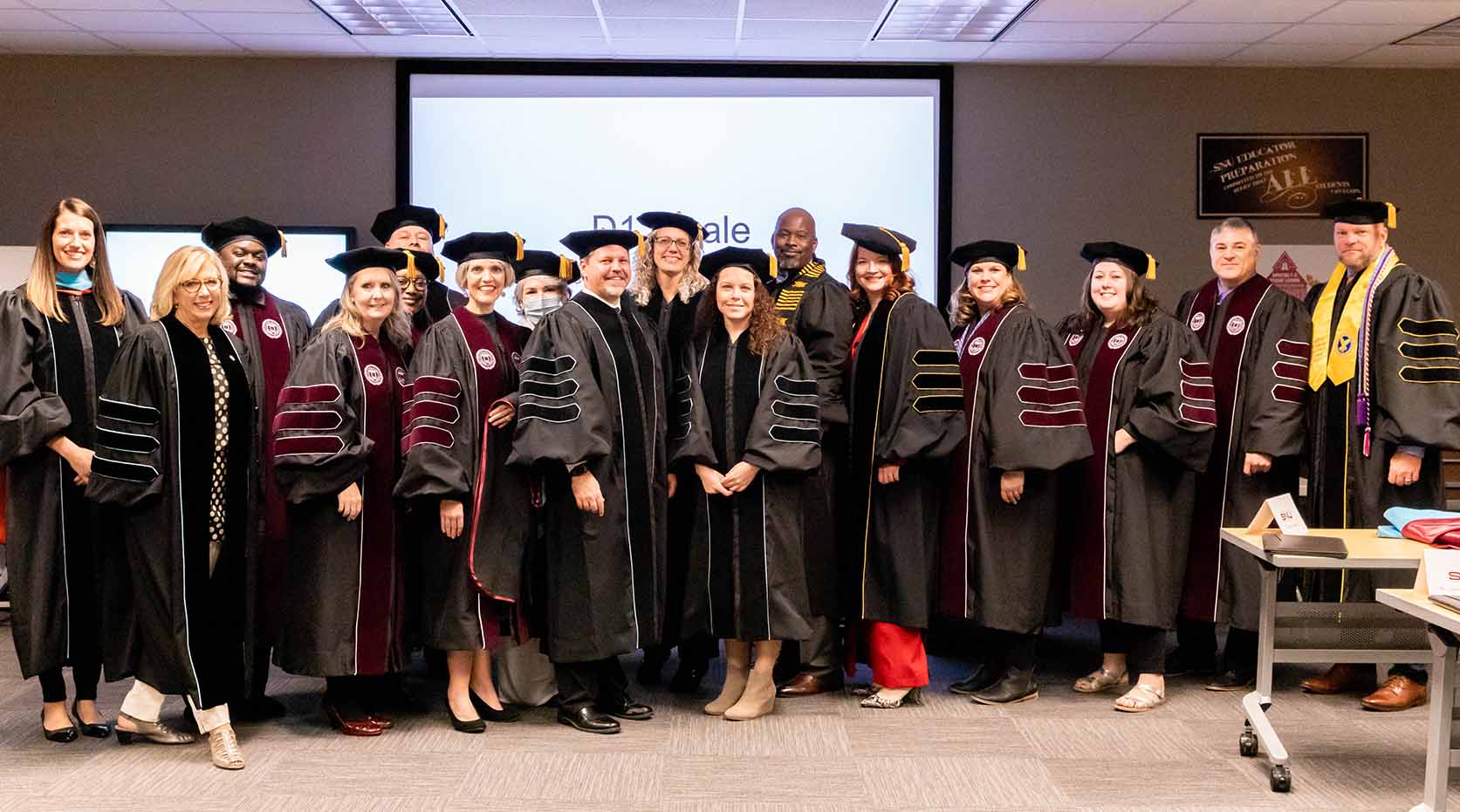 First DEAL Graduates standing in Regalia