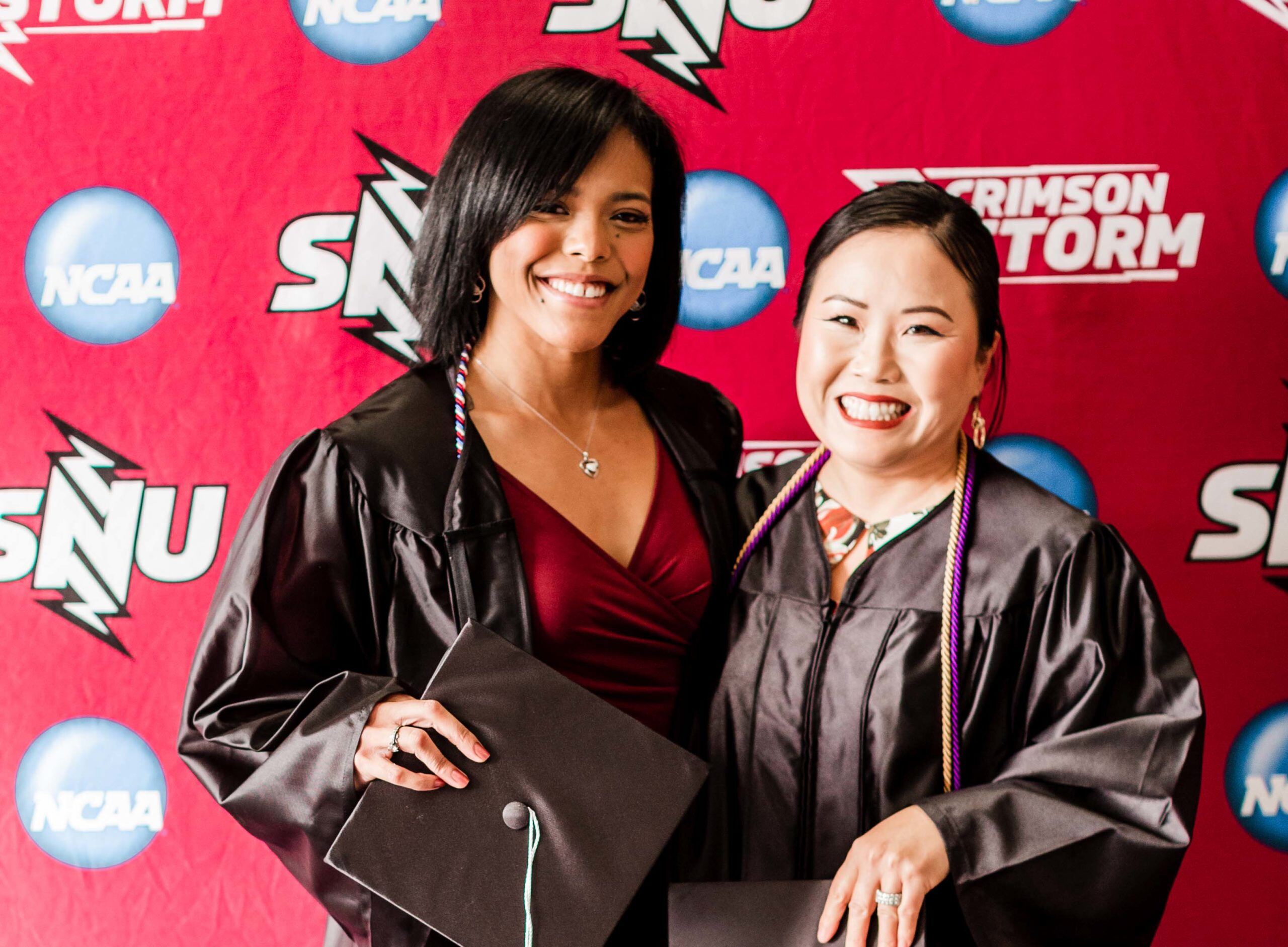 Bora and daughter dressed in graduation regalia