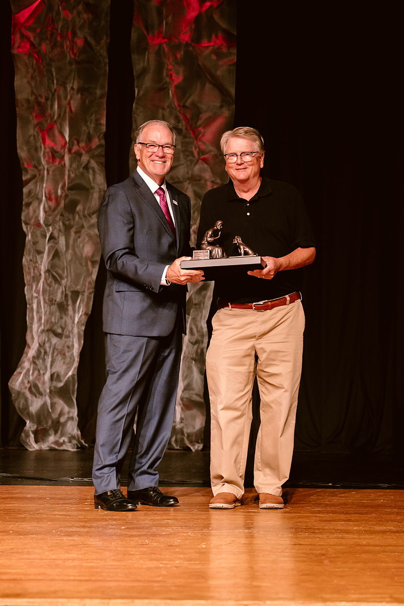 Phil white receiving award from Dr. Keith Newman