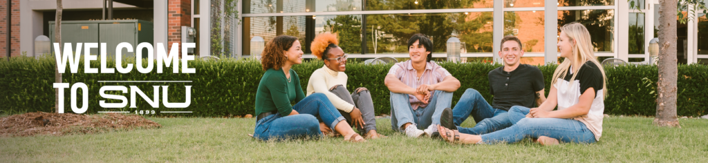 students sitting on the grass