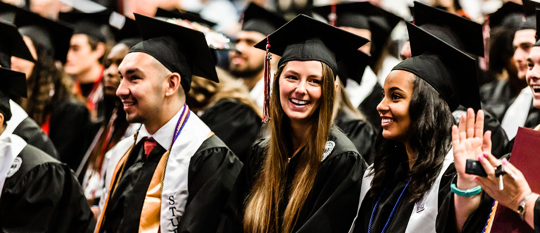 graduates smiling at commencement